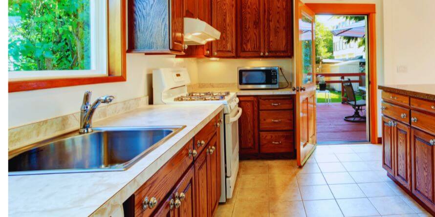 bright kitchen with carved wood cabinets